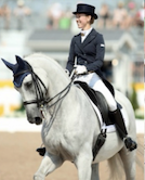 Ami riding a horse in dressage attire
