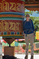 Bunny on a hiking trip beside a colourful prayer wheel
